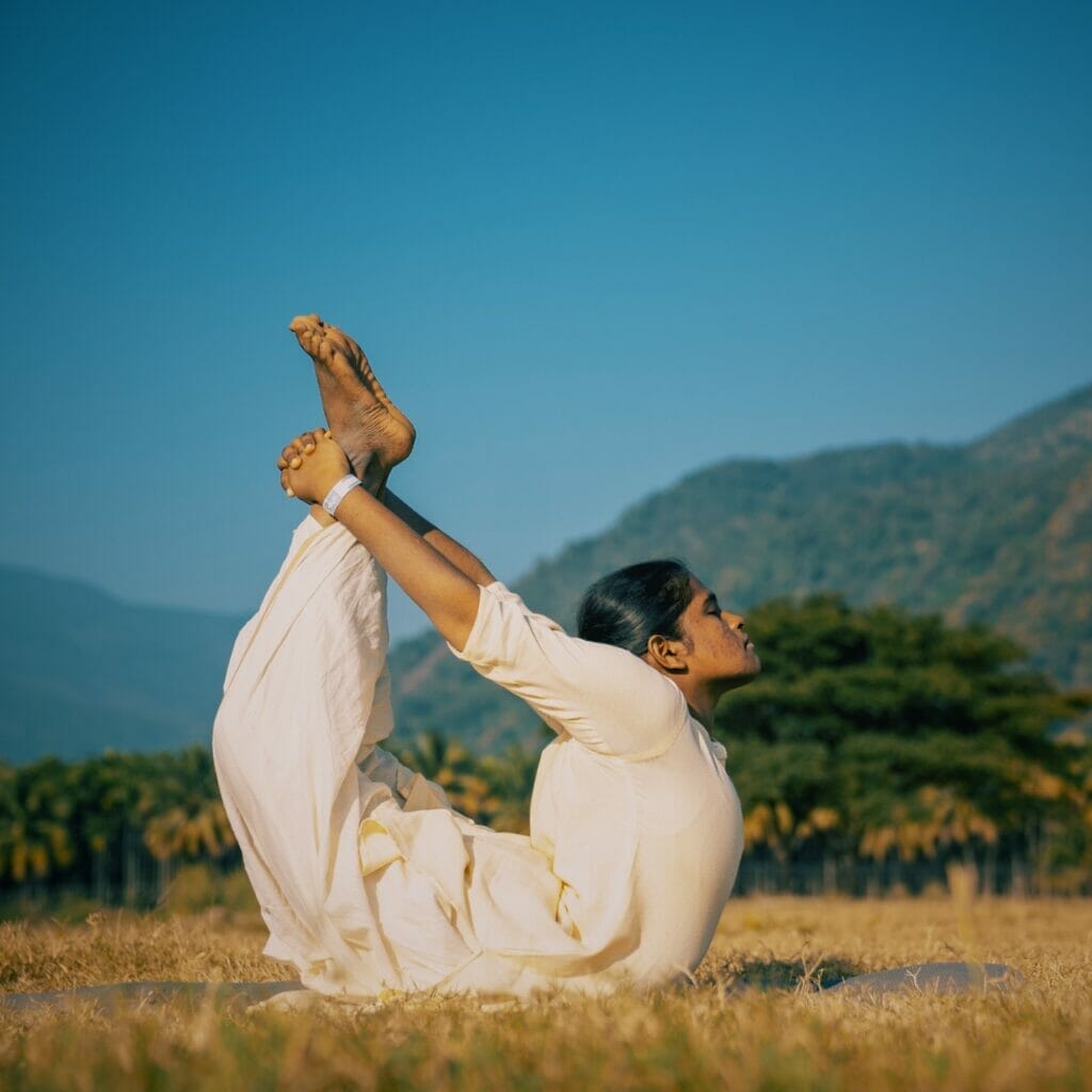 A woman practicing yoga in the breathtaking Indian mountains.
