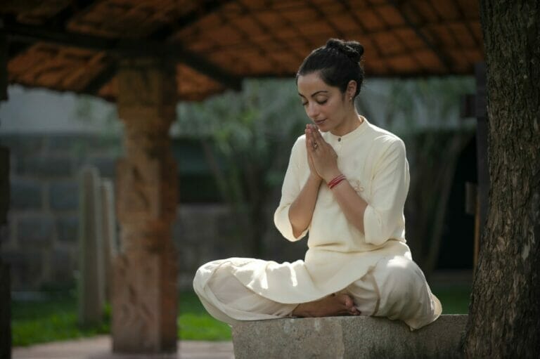 A woman practicing Hatha Yoga in a lotus pose at Aula Experimental.