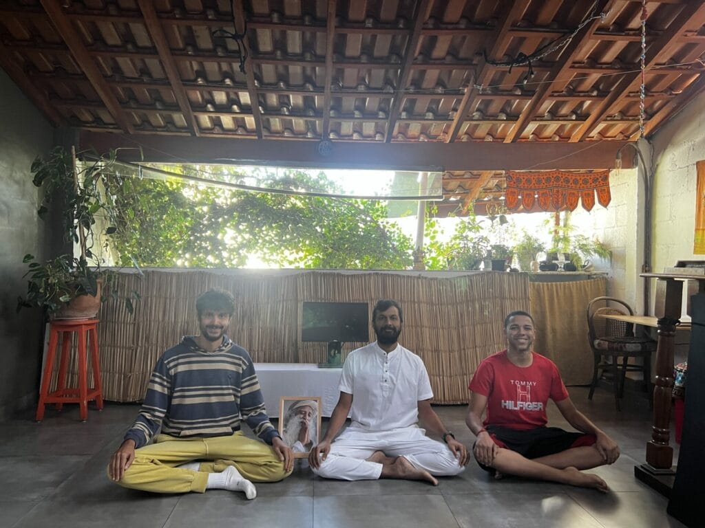 Three men meditating in a room.