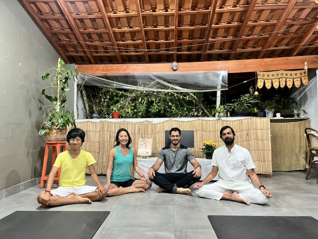 A group of people doing yoga in a room.