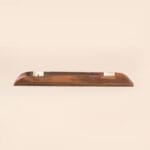 A wooden pen holder with a sleek, minimalist design placed on a neutral background.