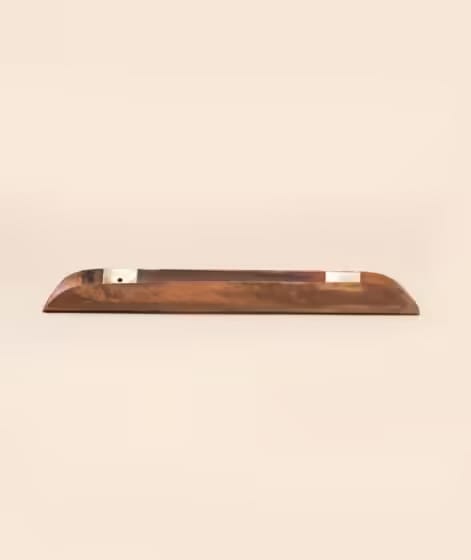 A wooden pen holder with a sleek, minimalist design placed on a neutral background.