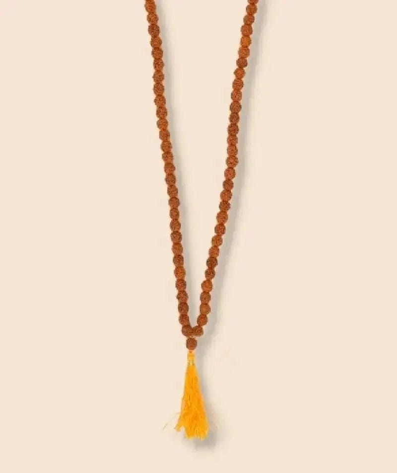 A rudraksha mala with brown beads and a yellow tassel.