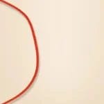 A red rope forms a loose loop on a beige background.